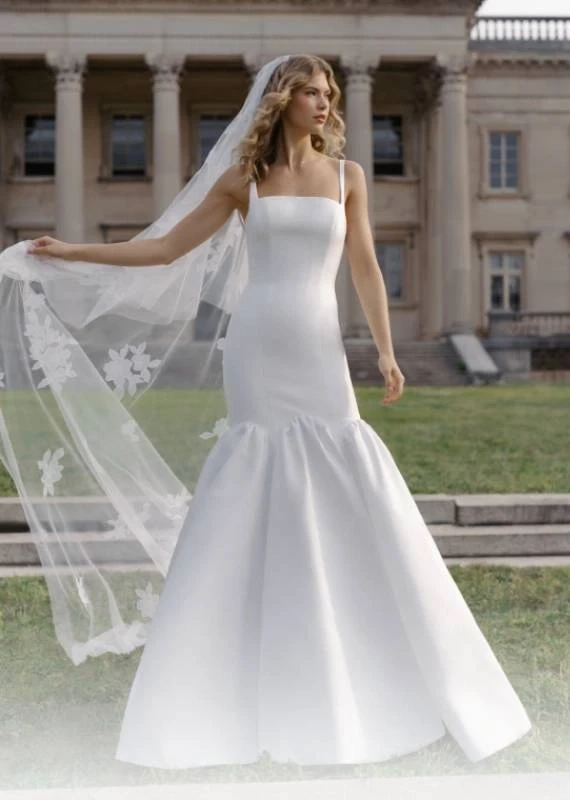 Model wearing a white Anne Barge Gown