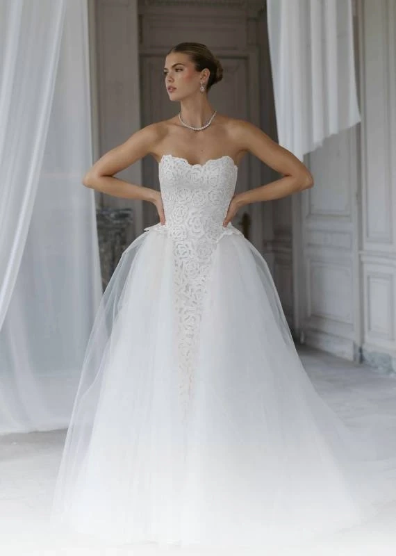 Model wearing a white a Anna Barge Couture Gown