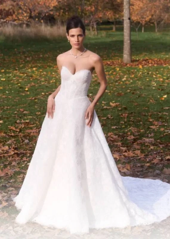 Model wearing a white Caroline Castigliano Gown