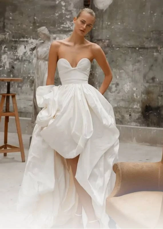 Model wearing a white Dana Harel Gown
