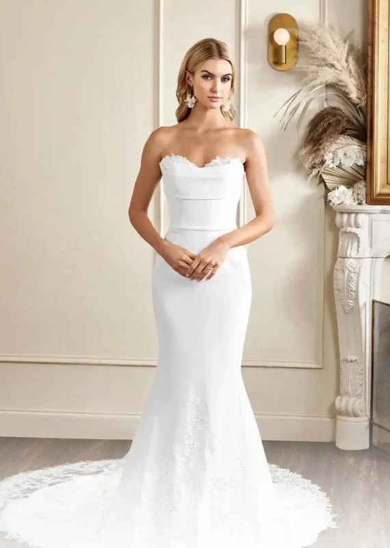 Model wearing a white Kelly Faetanini Gown