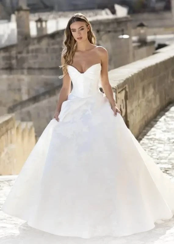 Model wearing a white Valentini Spose Gown