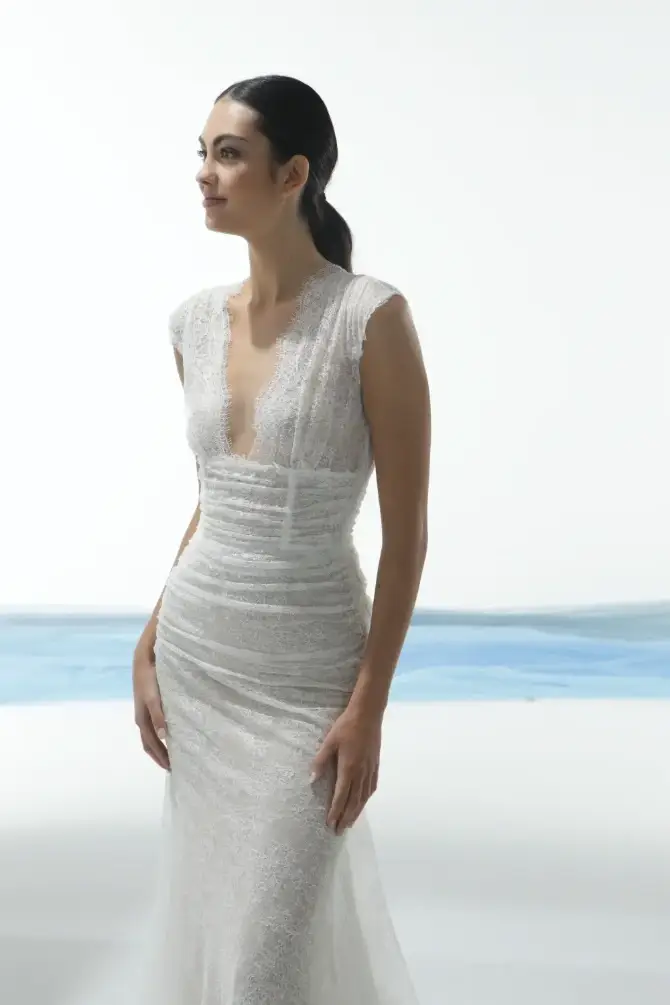 model is wearing an elegant white wedding dress 