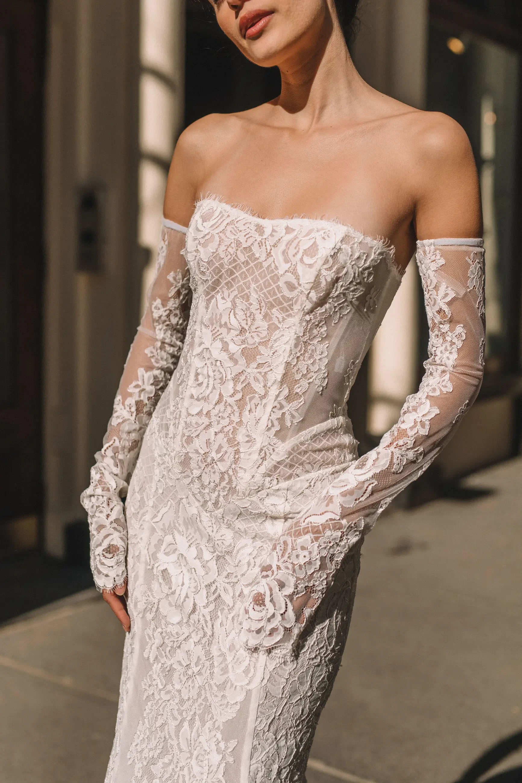 model is wearing an off the shoulder basque waist wedding gown
