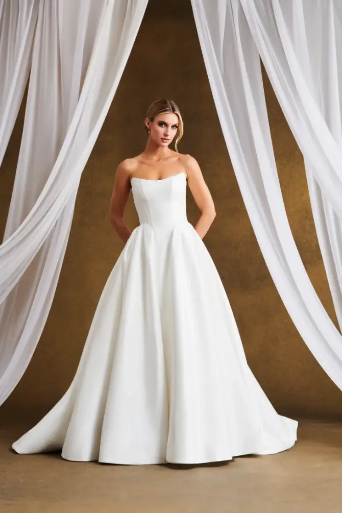 model is wearing a strapless ball gown wedding dress