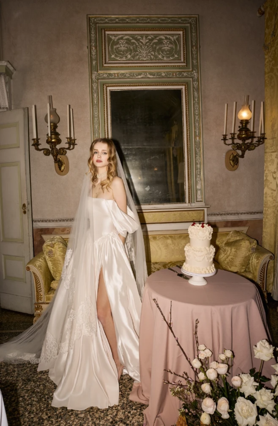 model is wearing an off the shoulder bridal gown