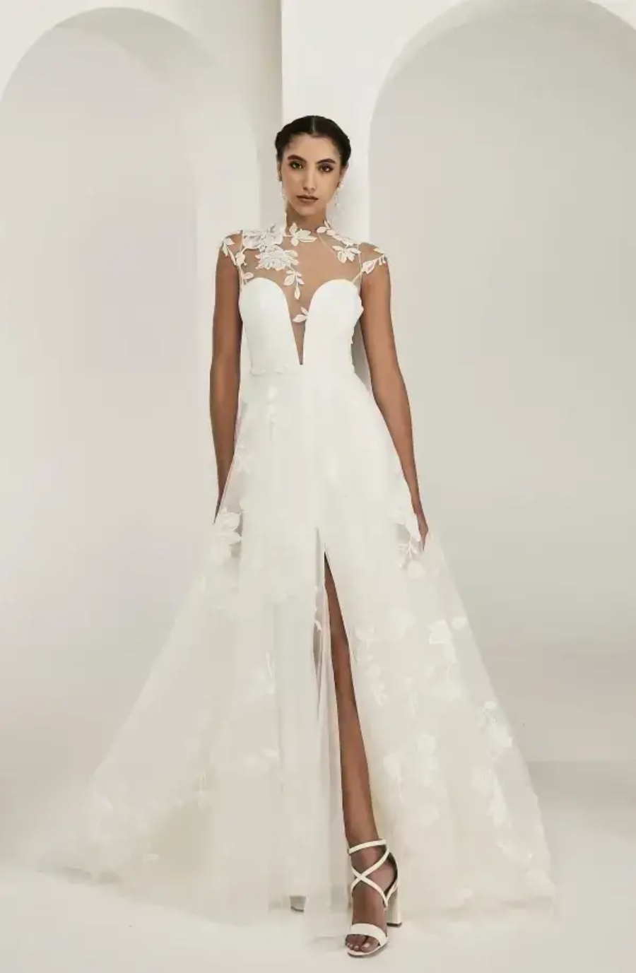 model is wearing a sleeveless a-line wedding dress