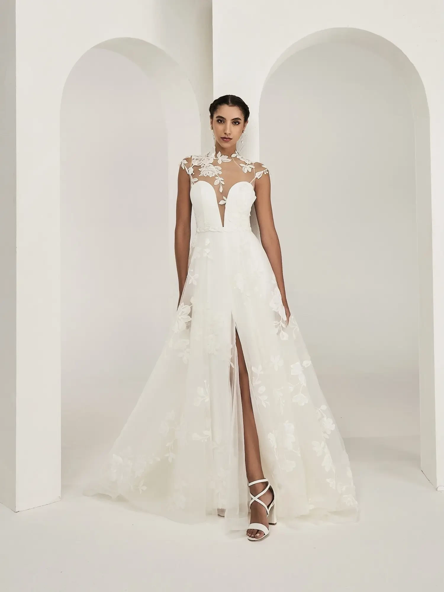 model is wearing an a-line wedding dress with a high illusion neckline