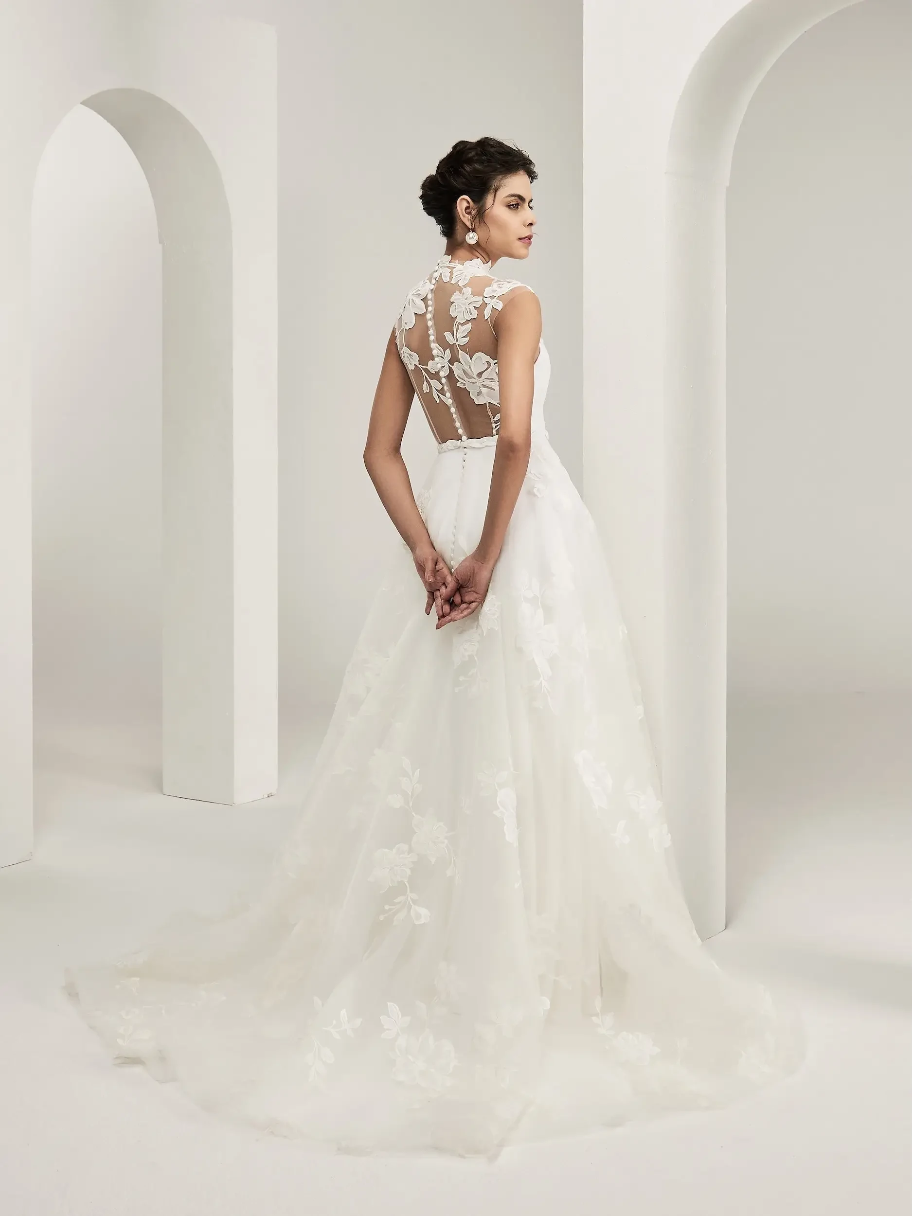 model is wearing an a-line wedding dress with a high illusion neckline