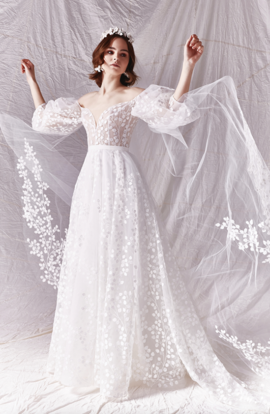 model is wearing a boho chic a-line bridal gown with blousy sleeves