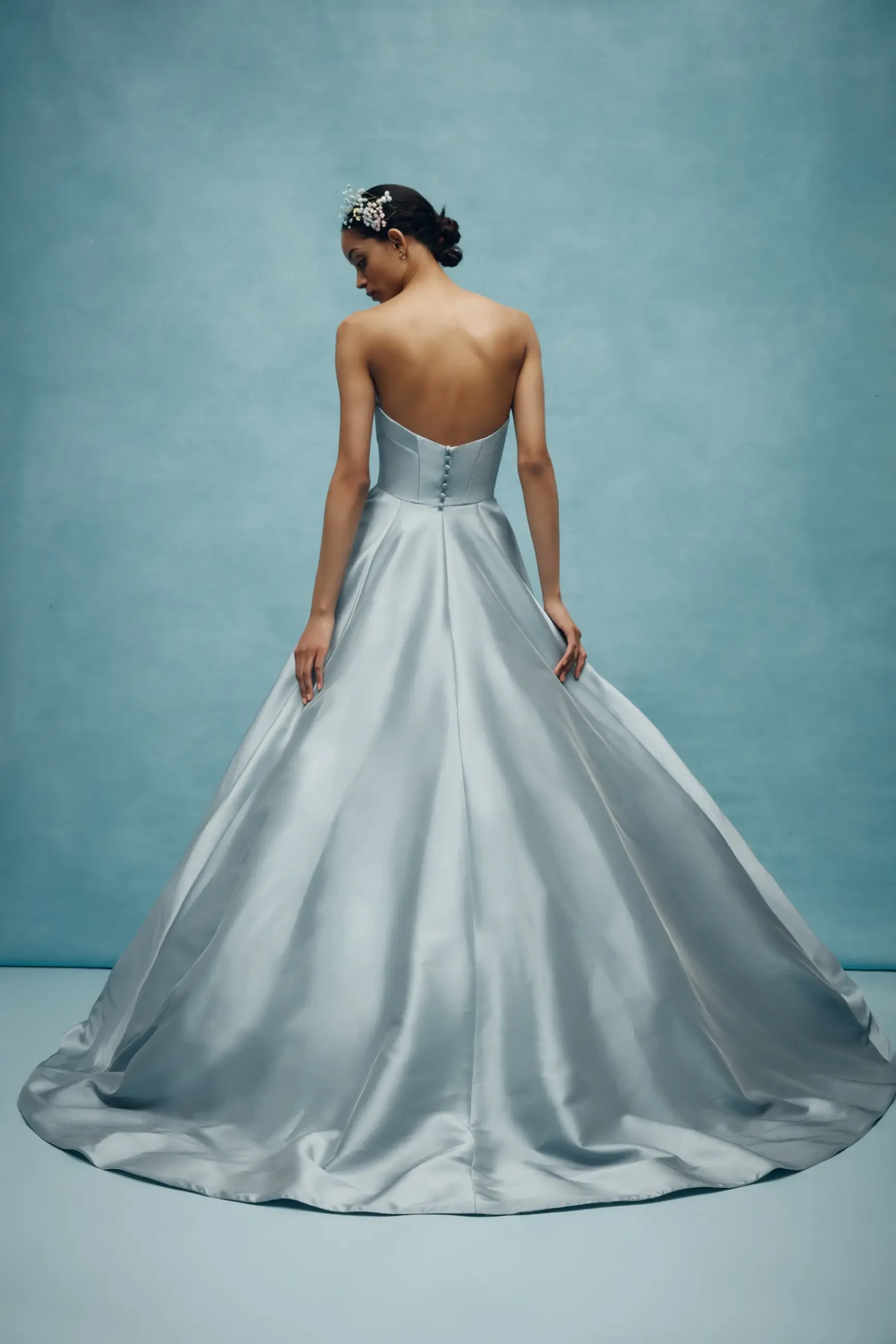 Model is wearing a mikado steel blue ball gown wedding dress by anne barge couture