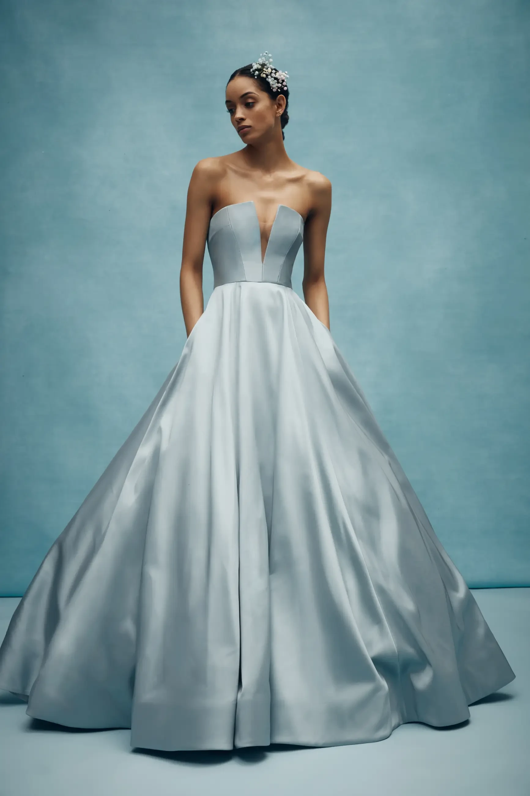Model is wearing a mikado steel blue ball gown wedding dress by anne barge couture