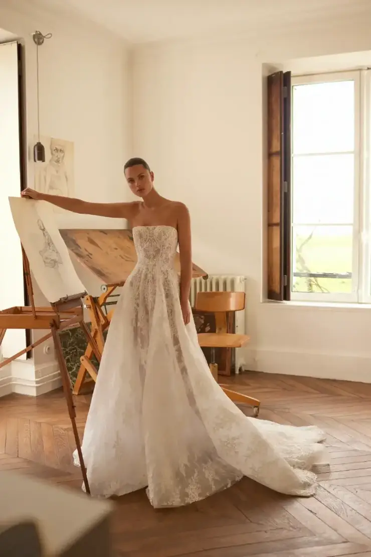 model is wearing a strapless a-line wedding dress