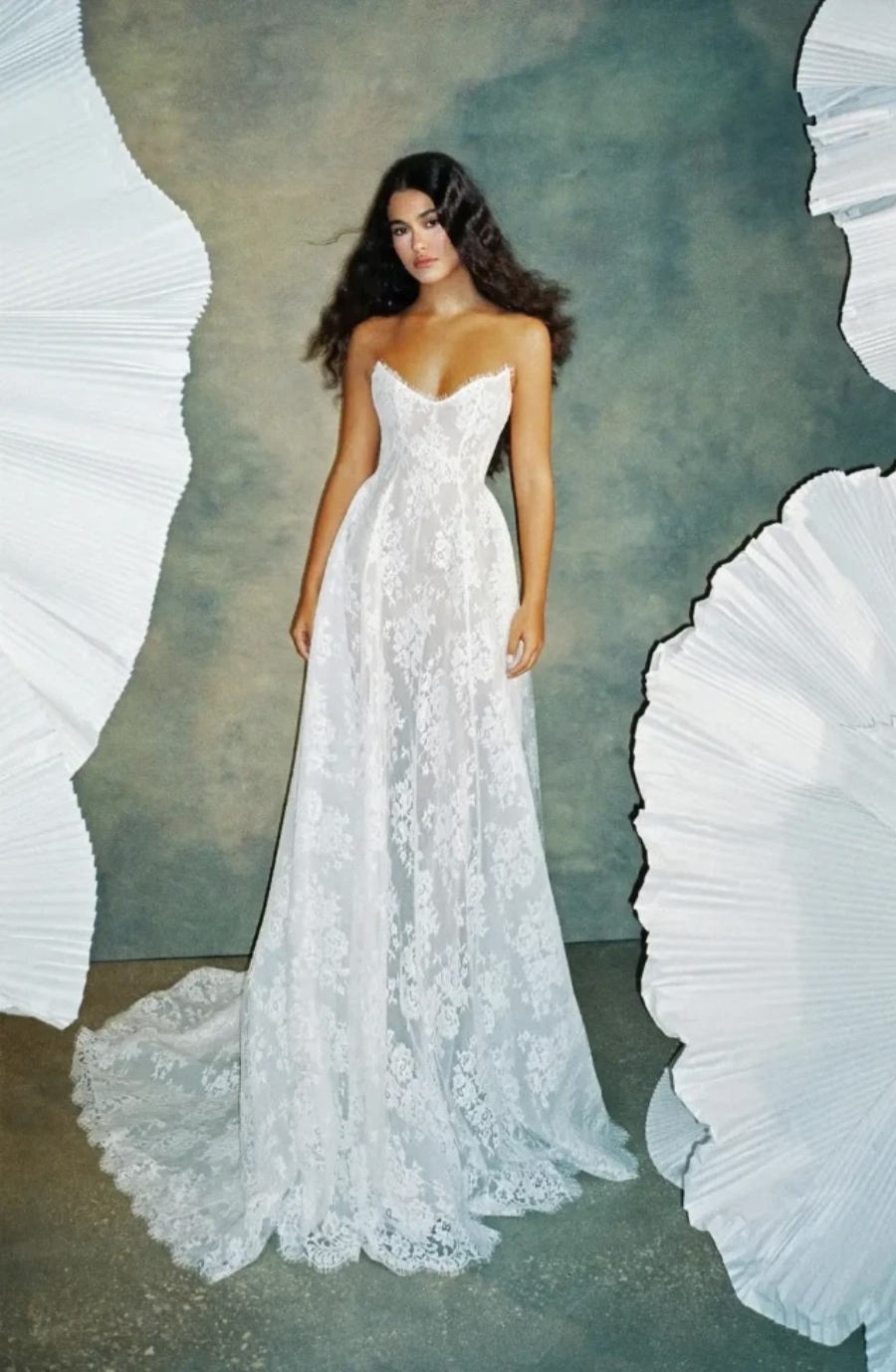 model is wearing a strapless a-line lace bridal gown