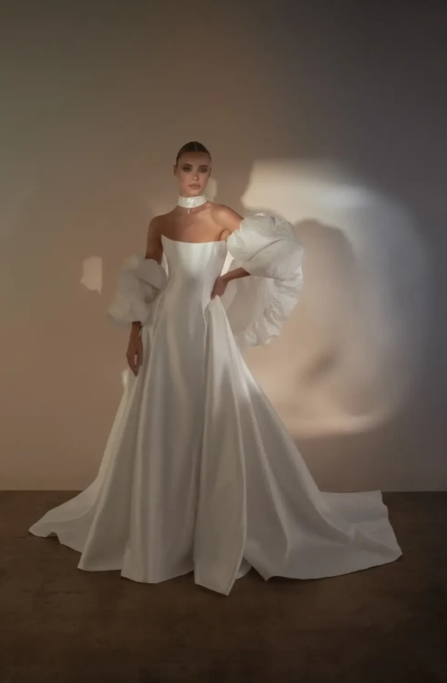 model is wearing a strapless ball gown wedding dress