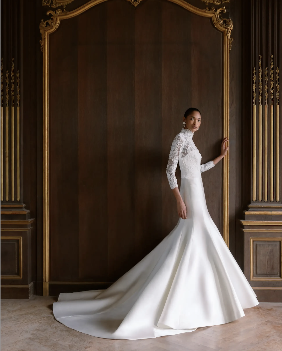 Model is wearing a strapless Italian Magnolia fit and flare gown with a straight-edge neckline and optional detachable 3D embroidered ¾ length bolero featuring a Chantilly trim high neckline.