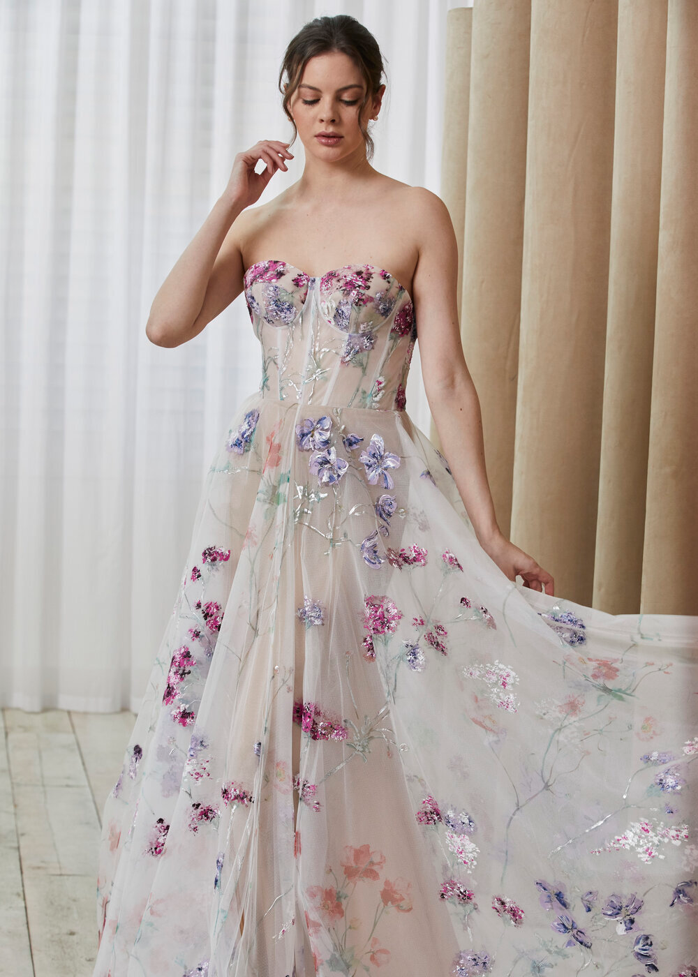 Model wearing a white a Calle Blanche Gown