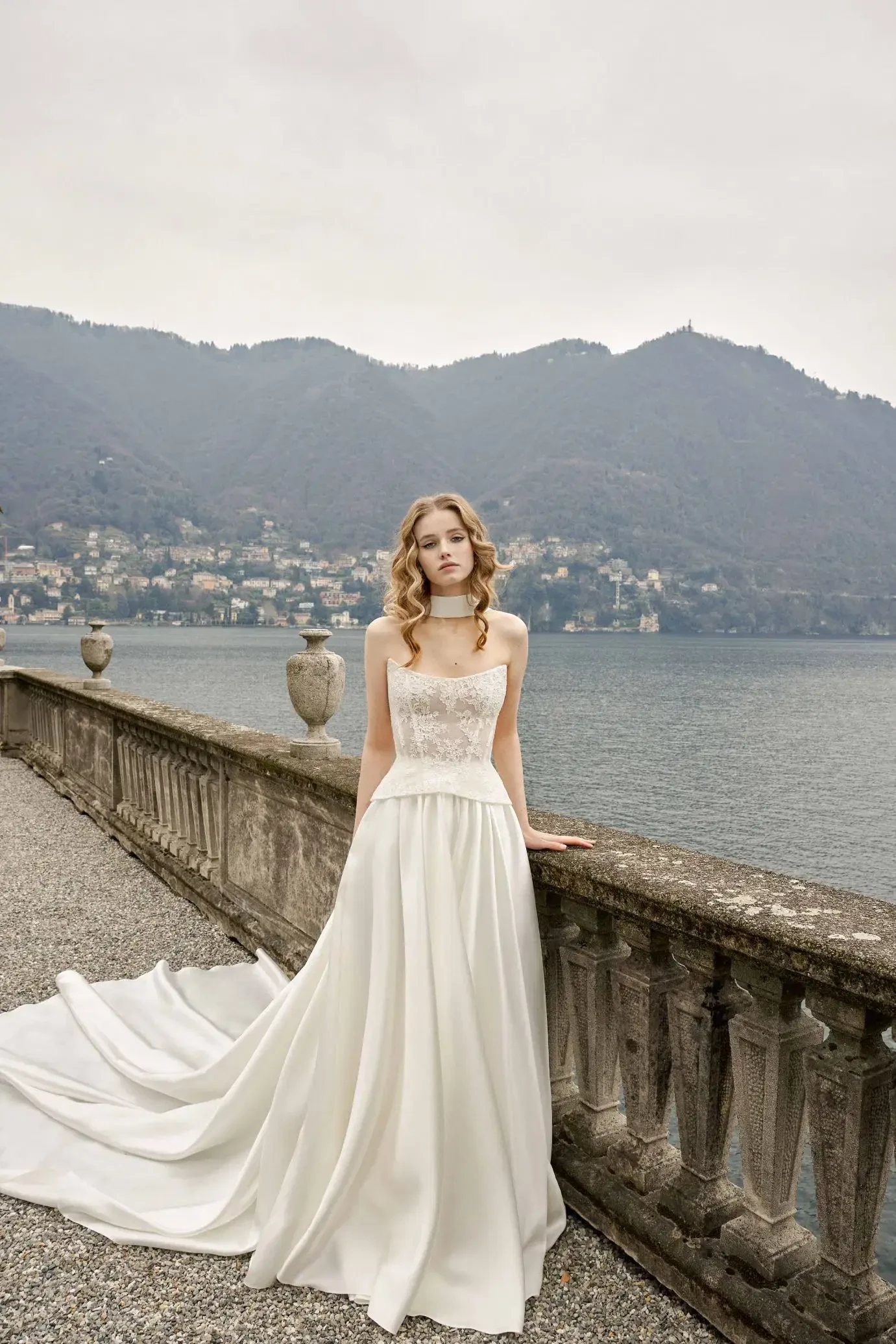 Model is wearing a two-piece gown with a lace top and classic skirt, creating a modern yet romantic silhouette.