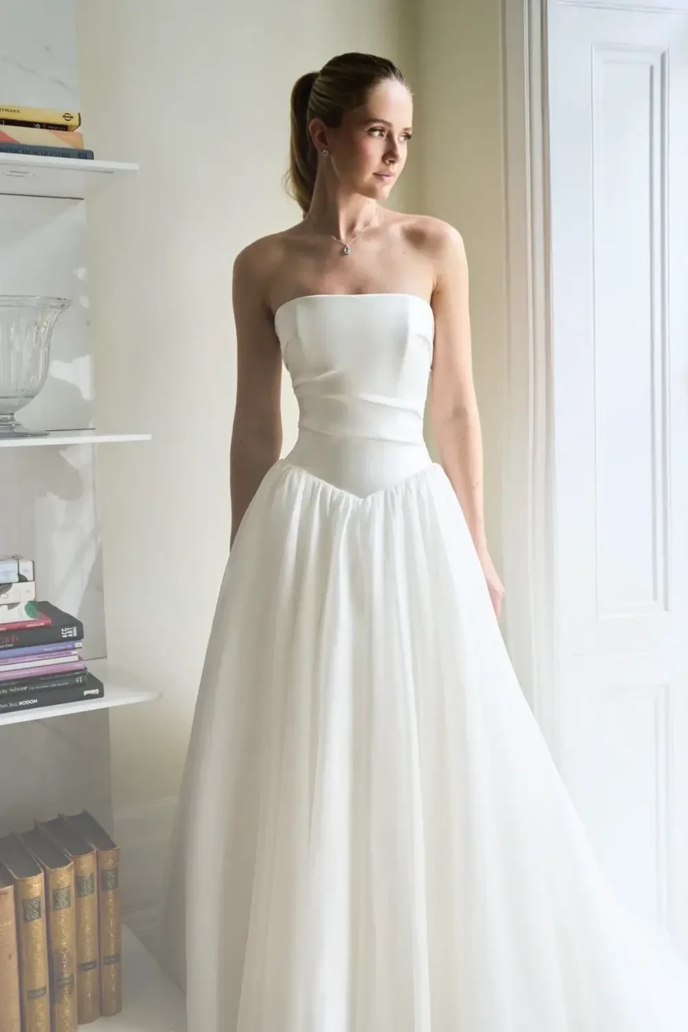 Model wearing a white Caroline Castigliano Gown