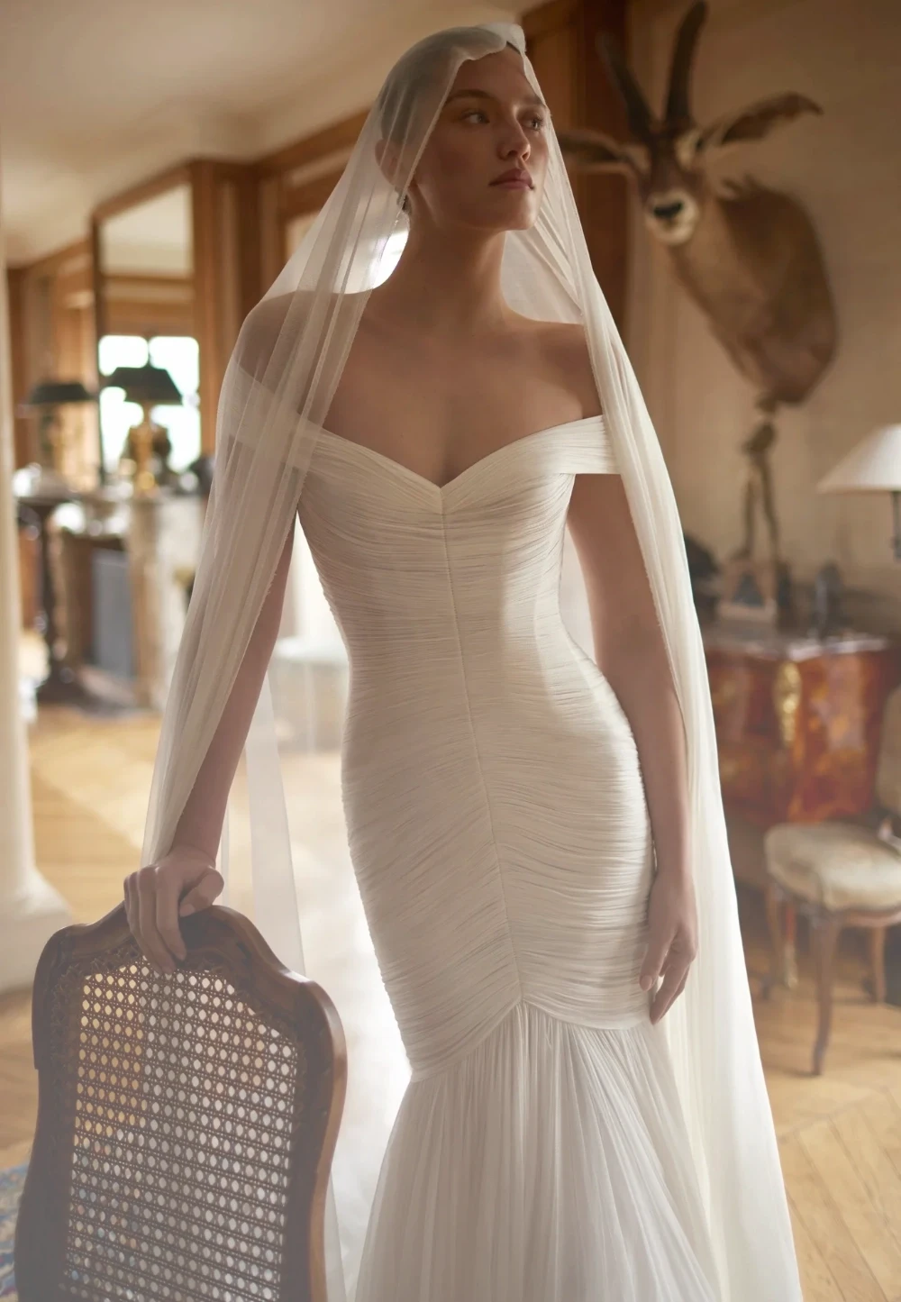 Model wearing a white Dana Harel Gown