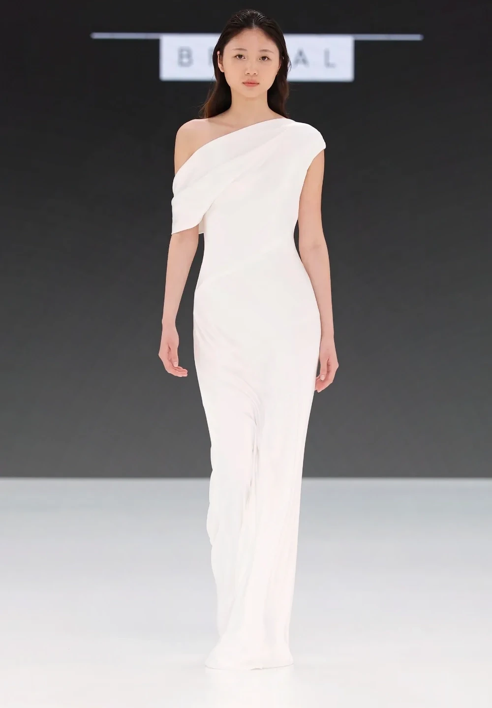 Model wearing a white a Sophie et Voilà Gown