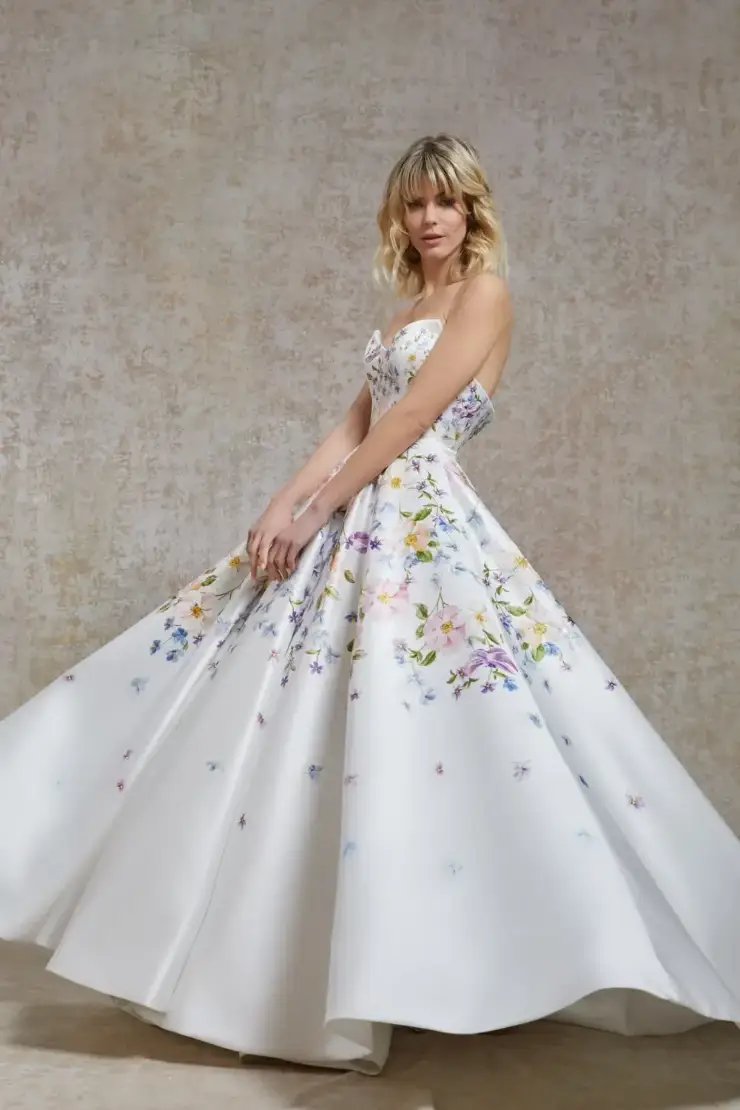 model is wearing a strapless a-line wearing dress with multicolored floral embroidery and pattern